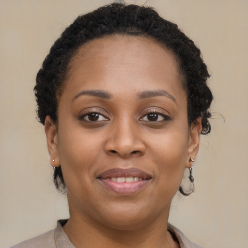 Joyful black young-adult female with short  brown hair and brown eyes