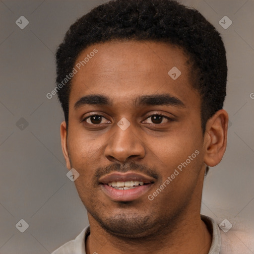 Joyful black young-adult male with short  black hair and brown eyes