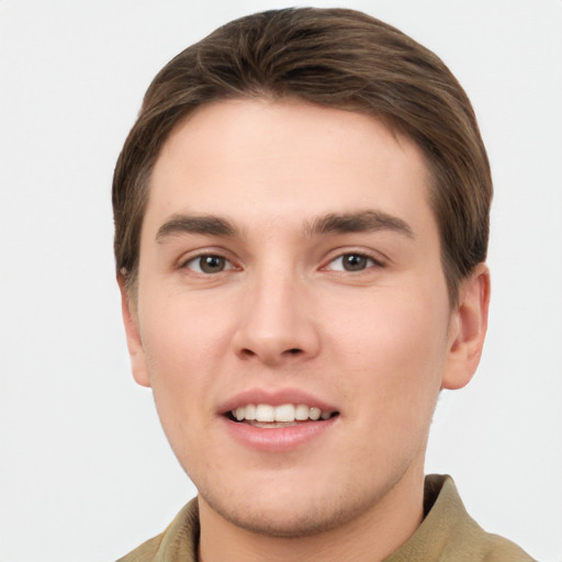 Joyful white young-adult male with short  brown hair and grey eyes