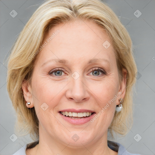 Joyful white adult female with medium  brown hair and blue eyes