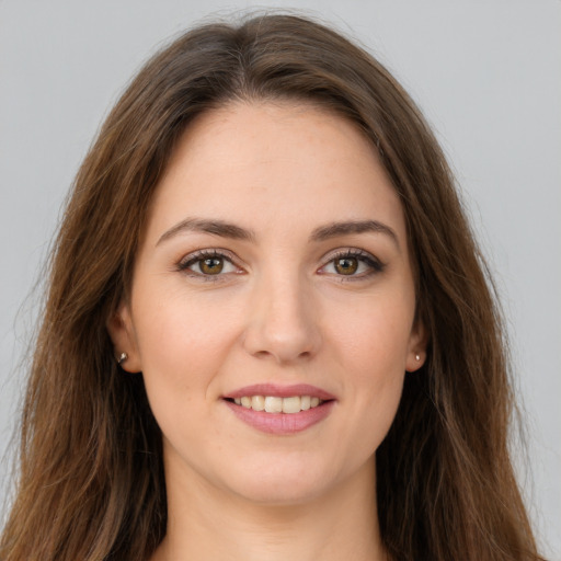 Joyful white young-adult female with long  brown hair and grey eyes