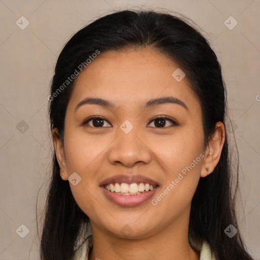 Joyful latino young-adult female with long  brown hair and brown eyes