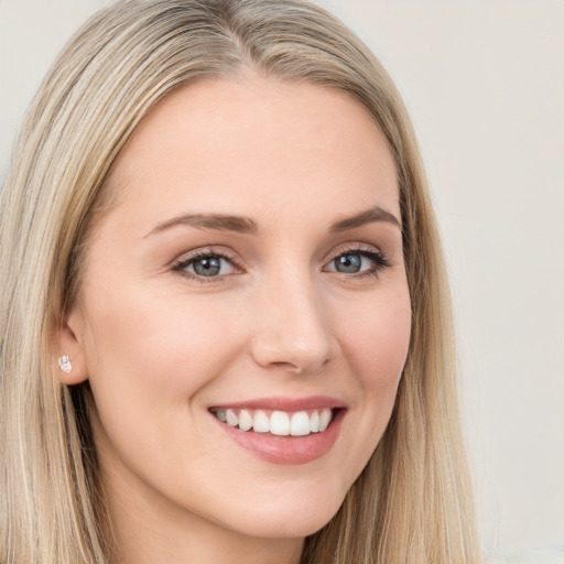 Joyful white young-adult female with long  brown hair and blue eyes