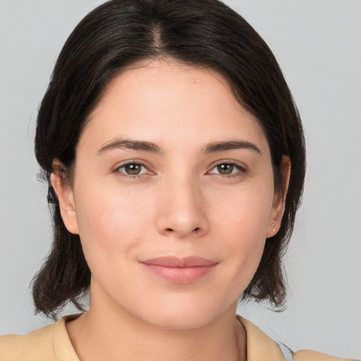 Joyful white young-adult female with medium  brown hair and brown eyes