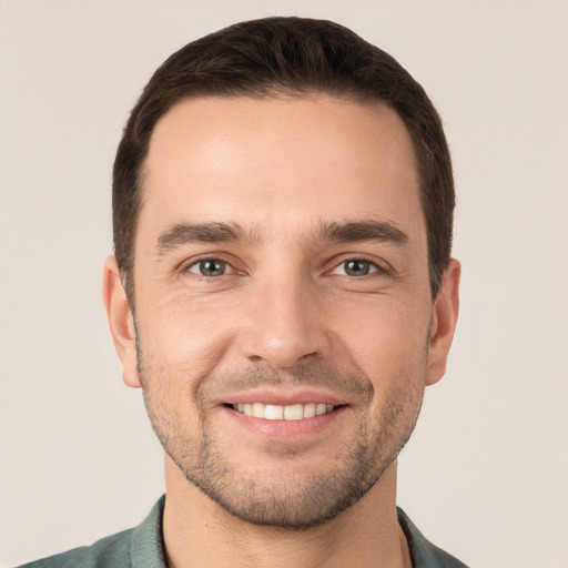 Joyful white young-adult male with short  brown hair and brown eyes