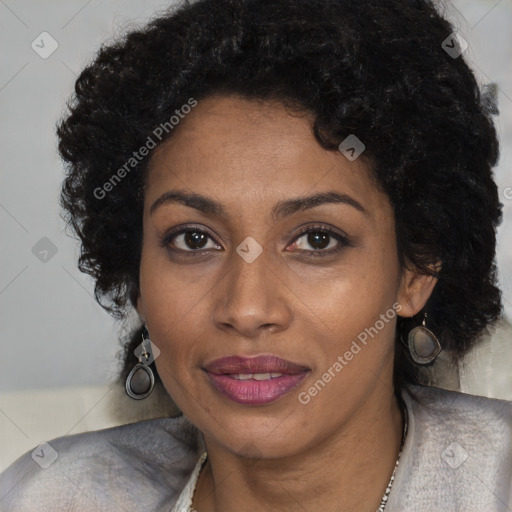 Joyful black young-adult female with long  black hair and brown eyes