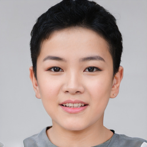 Joyful asian child female with short  black hair and brown eyes