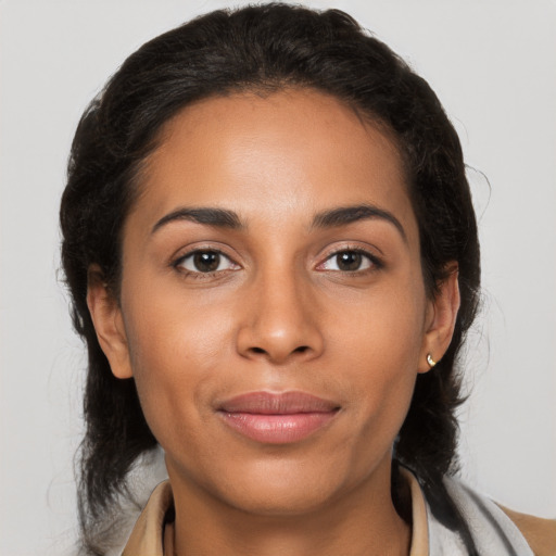 Joyful latino young-adult female with medium  brown hair and brown eyes