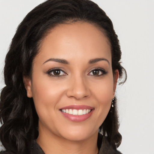 Joyful latino young-adult female with long  brown hair and brown eyes