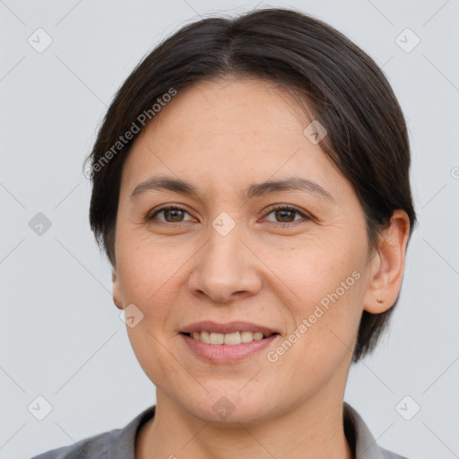 Joyful white adult female with short  brown hair and brown eyes