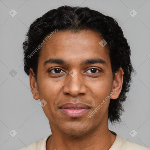 Joyful black young-adult male with short  black hair and brown eyes