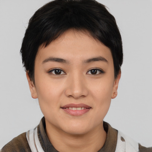 Joyful asian young-adult female with short  brown hair and brown eyes