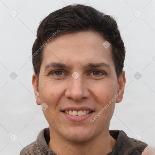 Joyful white adult male with short  brown hair and grey eyes