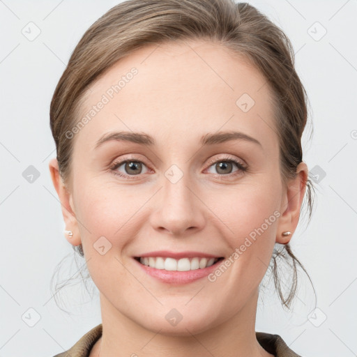 Joyful white young-adult female with medium  brown hair and grey eyes