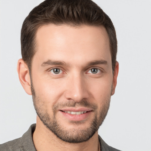 Joyful white young-adult male with short  brown hair and brown eyes