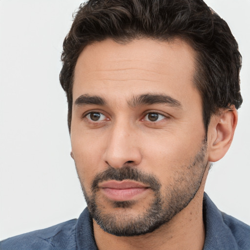 Joyful white young-adult male with short  black hair and brown eyes