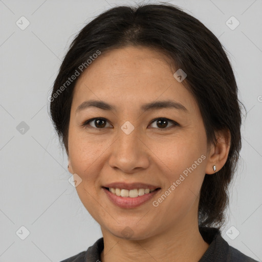 Joyful asian adult female with medium  brown hair and brown eyes