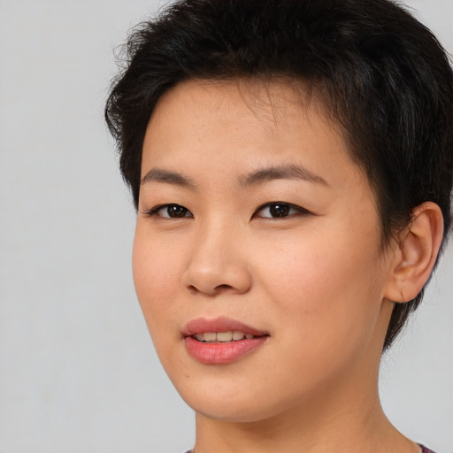 Joyful asian young-adult female with short  brown hair and brown eyes