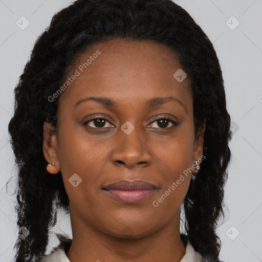 Joyful black young-adult female with long  brown hair and brown eyes