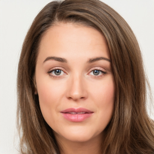 Joyful white young-adult female with long  brown hair and green eyes