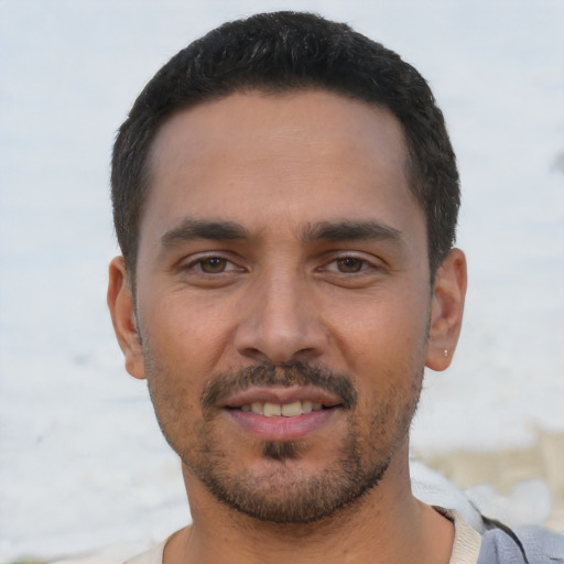 Joyful white young-adult male with short  black hair and brown eyes