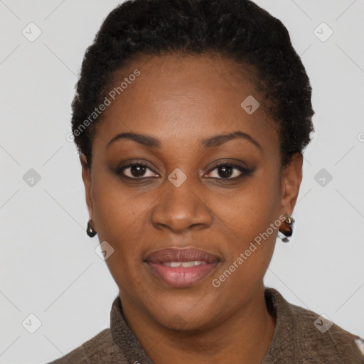 Joyful black young-adult female with short  black hair and brown eyes