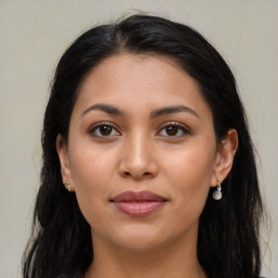 Joyful latino young-adult female with long  brown hair and brown eyes