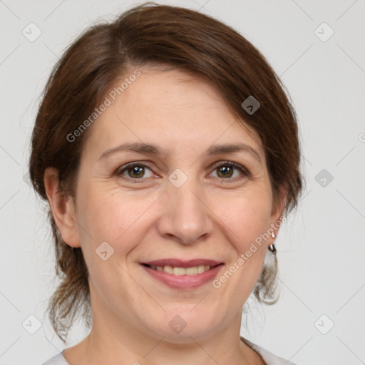 Joyful white adult female with medium  brown hair and grey eyes