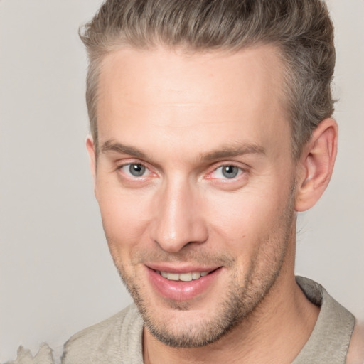 Joyful white adult male with short  brown hair and brown eyes