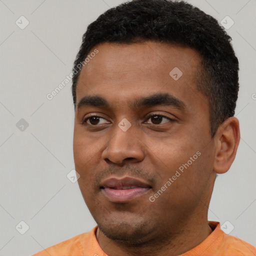 Joyful latino young-adult male with short  black hair and brown eyes