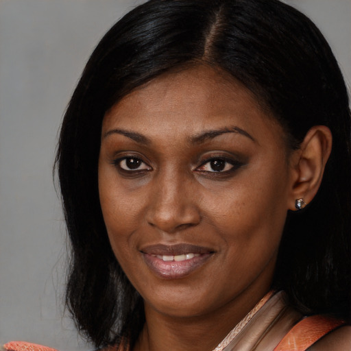 Joyful black adult female with medium  brown hair and brown eyes