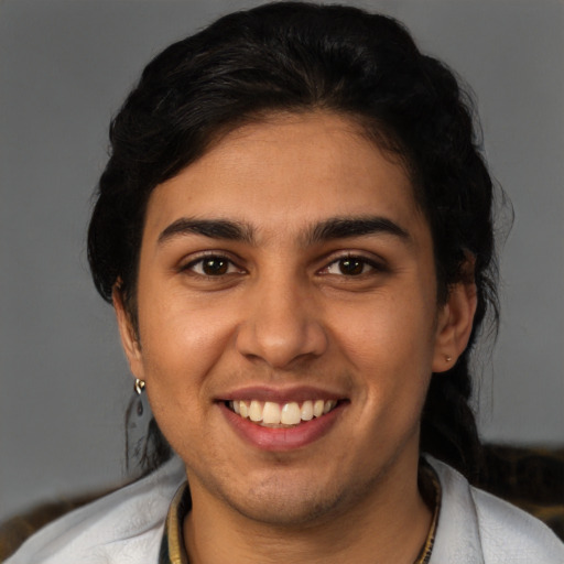 Joyful latino young-adult female with short  black hair and brown eyes