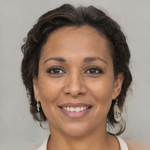 Joyful white adult female with medium  brown hair and brown eyes