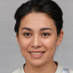 Joyful asian young-adult female with short  brown hair and brown eyes