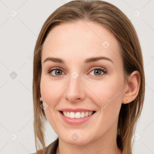 Joyful white young-adult female with long  brown hair and blue eyes