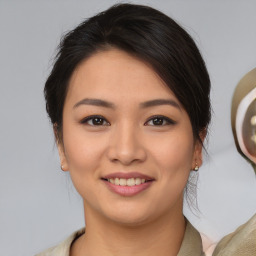 Joyful latino young-adult female with medium  brown hair and brown eyes