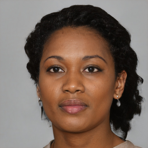Joyful black young-adult female with medium  black hair and brown eyes