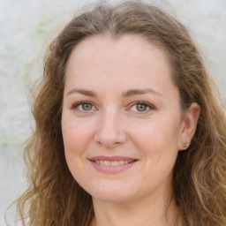 Joyful white young-adult female with long  brown hair and green eyes