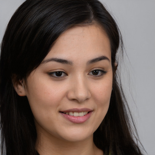 Joyful asian young-adult female with long  brown hair and brown eyes