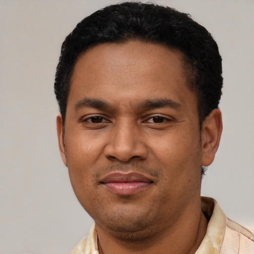 Joyful latino adult male with short  black hair and brown eyes