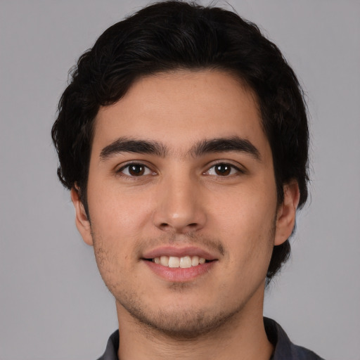 Joyful white young-adult male with short  black hair and brown eyes