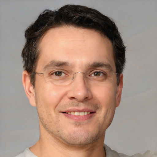 Joyful white adult male with short  brown hair and brown eyes