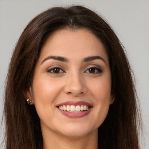 Joyful white young-adult female with long  brown hair and brown eyes