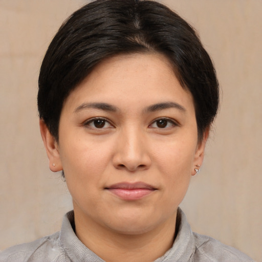 Joyful asian young-adult female with short  brown hair and brown eyes