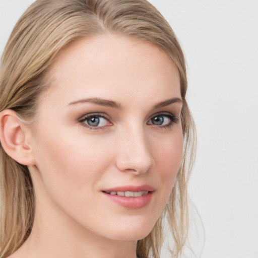 Joyful white young-adult female with long  brown hair and blue eyes