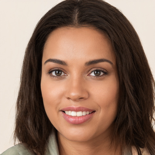 Joyful white young-adult female with long  brown hair and brown eyes