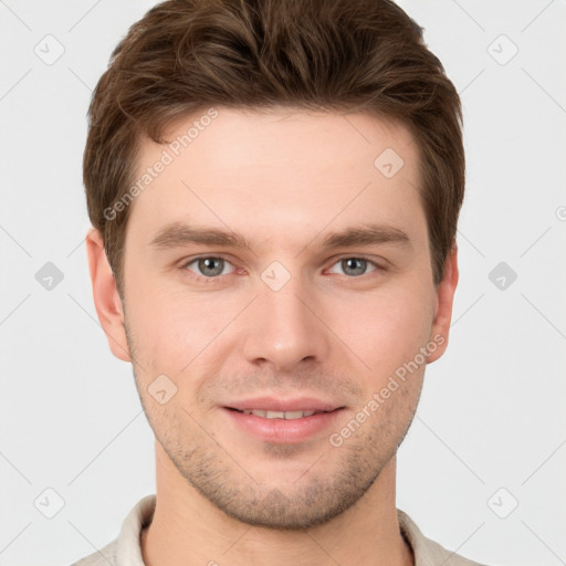 Joyful white young-adult male with short  brown hair and grey eyes