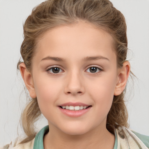 Joyful white child female with medium  brown hair and brown eyes