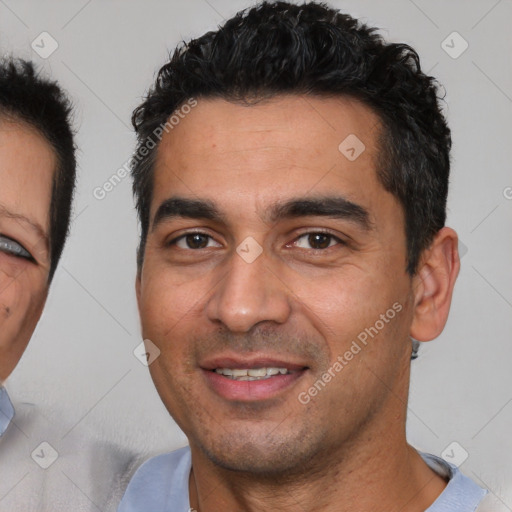 Joyful white young-adult male with short  black hair and brown eyes