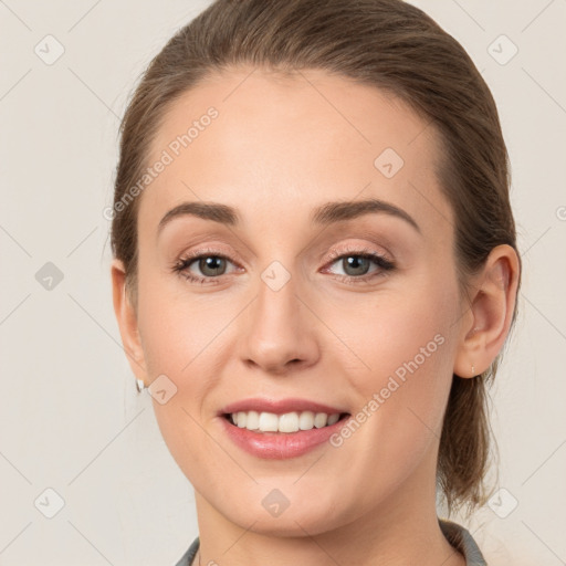 Joyful white young-adult female with medium  brown hair and grey eyes